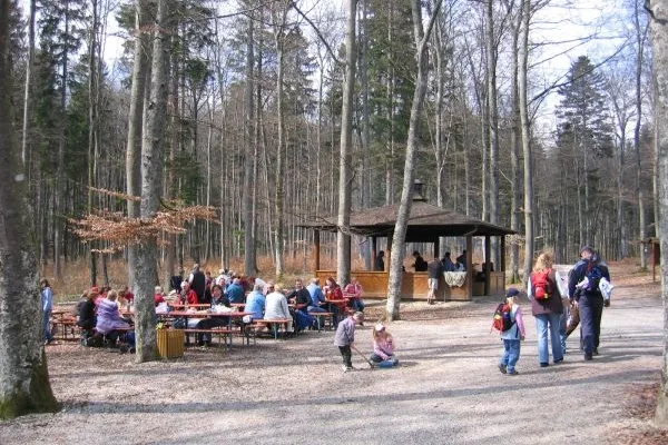 Bild von Rastplatz im Wald mit Schutzhütte an der Kolbinger Höhle. Die Bierbänke sind von vielen Wanderern besetzt